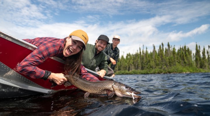 A woman who has just caught her pike