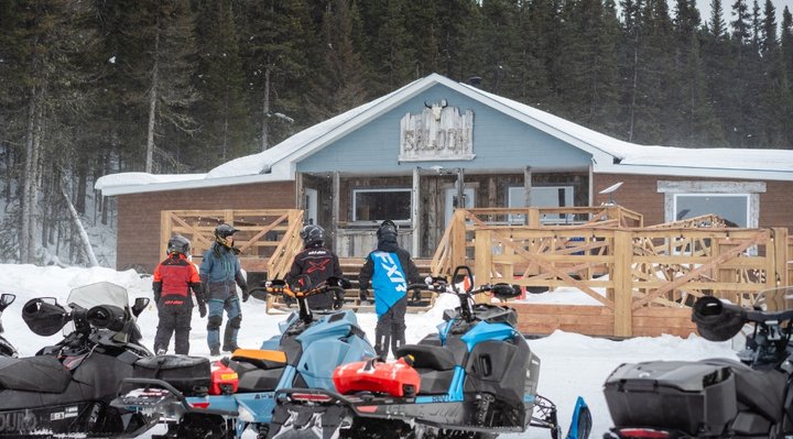 Snowmobilers stopping at a snowmobile relay