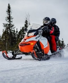 Two people on a snowmobile 